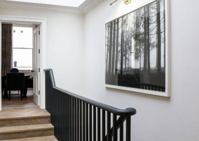 Penman Interiors Chelsea Hallways Atrium Glass Herringbone Floor Black Staircase Monochromatic Art Photography