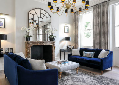 Penman Interiors Chelsea Living Room Blue Cobalt Sofa Grey Ottoman Restored Fireplace Grey Styling Black Accents