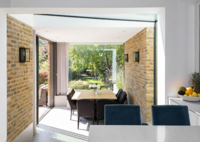 Penman Interiors Dulwich Kitchen Diner Teal Velvet Stools Square Dining Table Exposed Brick Sheer Curtains